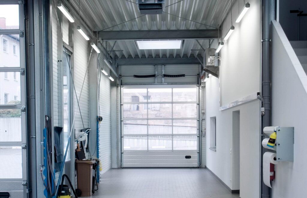 Garageinteriör med takmonterade linjära LED-armaturer från PROLJUS AB som levererar jämnt, energieffektivt arbetsljus och modern estetik perfekt för verkstäder och industrilokaler