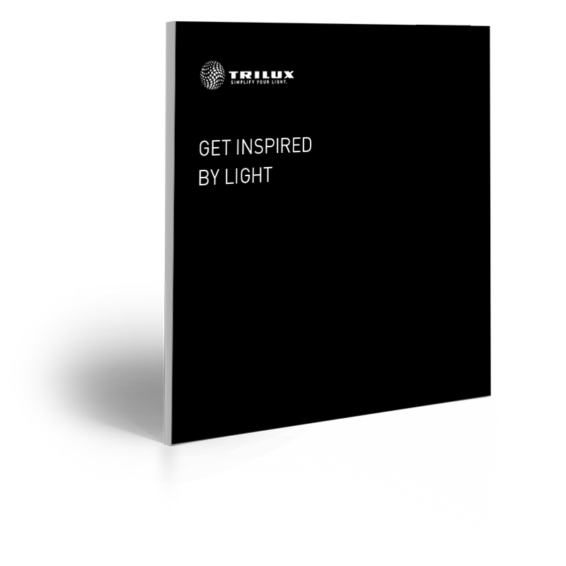 Svart katalogomslag med Trilux-logotyp och texten Get Inspired By Light, lockar till att upptäcka PROLJUS AB:s moderna och energieffektiva belysningsarmaturer för kommersiella och offentliga miljöer