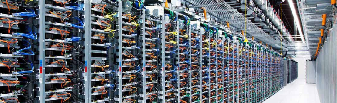 Lång datacenterkorridor med rader av servrar upplysta av energieffektiva PROLJUS AB:s LED-armaturer som ger klar, jämn arbetsbelysning, förbättrad sikt och låga driftkostnader, perfekt för företag som vill uppgradera belysningen