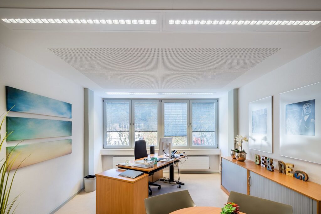 Kontorsrum med infällda rektangulära LED-armaturer i taket och linjära armaturer över fönstren som ger jämnt, bländfritt och energieffektivt ljus, stilrena lösningar från PROLJUS AB för moderna arbetsmiljöer