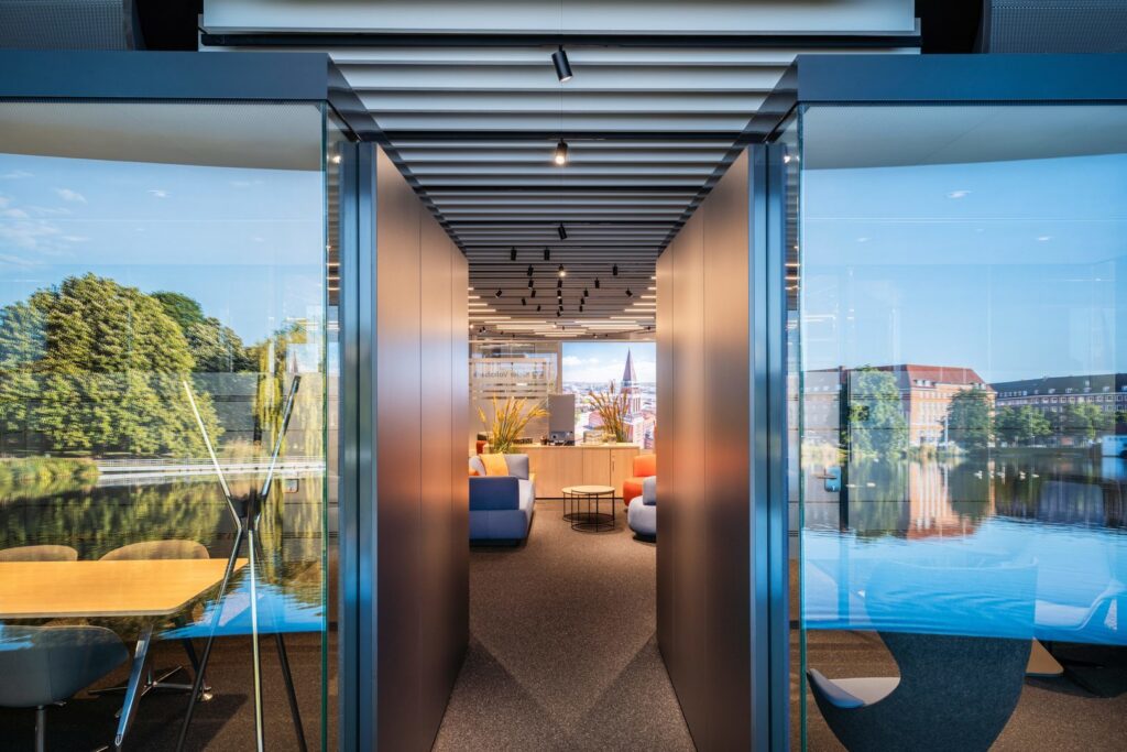 Modernt kontor med glasväggar och takmonterade infällda och riktbara spotlights samt trackarmaturer som ger varm, jämn och energieffektiv belysning och visar PROLJUS ABs premiumarmaturer perfekta för kontors- och loungeytor